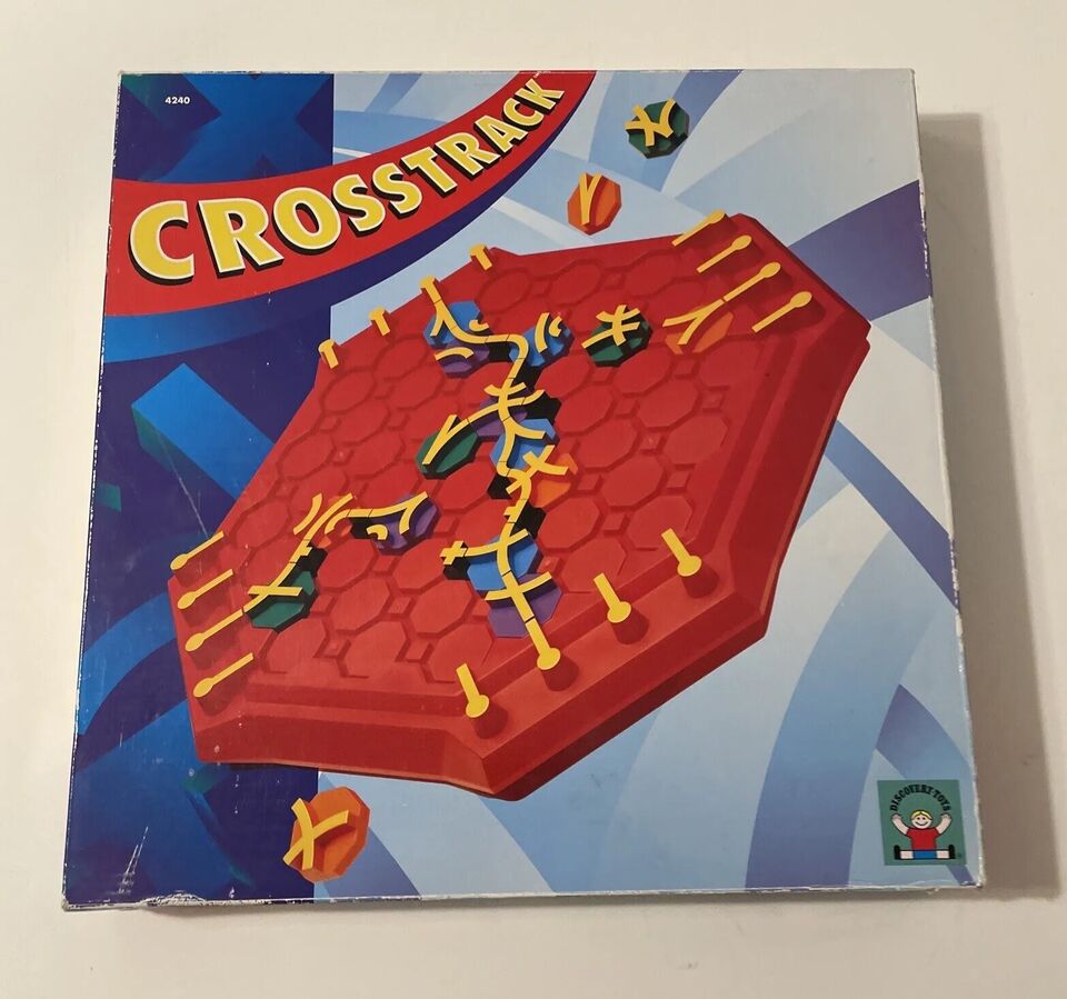 Box cover of the board game "Crosstrack," featuring a stylized depiction of a red hexagonal board with yellow tracks and multi-colored game pieces, set against a blue geometric background.