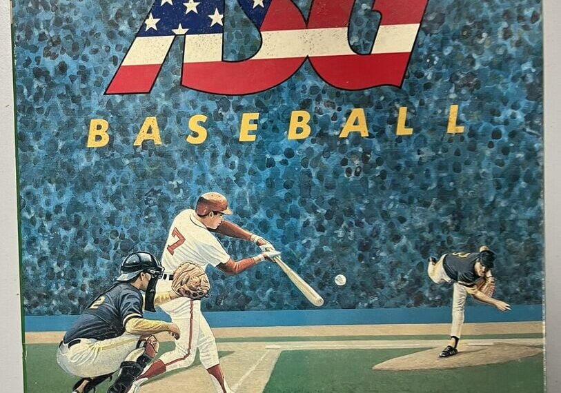 "Vintage ASG Baseball board game cover featuring an illustrated scene of a baseball batter, catcher, and pitcher in action, with a blue speckled background and the ASG logo adorned in the American flag colors at the top; the MLB logo is present at the bottom."