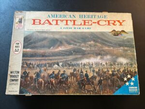 "Vintage 'American Heritage Battle-Cry' Civil War board game box by Milton Bradley Company, showing illustrated cavalry and soldiers in battle on the cover."