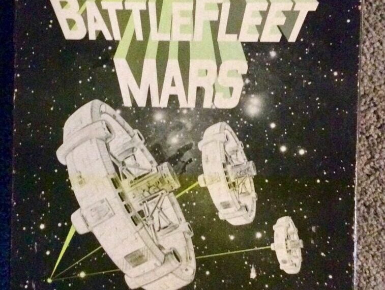 An image of the cover art for "Battlefleet Mars," a future-history simulation game, with the text "the time is: 1 January 2096 A.D." prominently displayed. The cover features stylized text and images of spacecraft against a starry background, indicating a space combat theme set in the 21st century. The company logo "SPI" is visible at the bottom, along with credit to the game's designers.