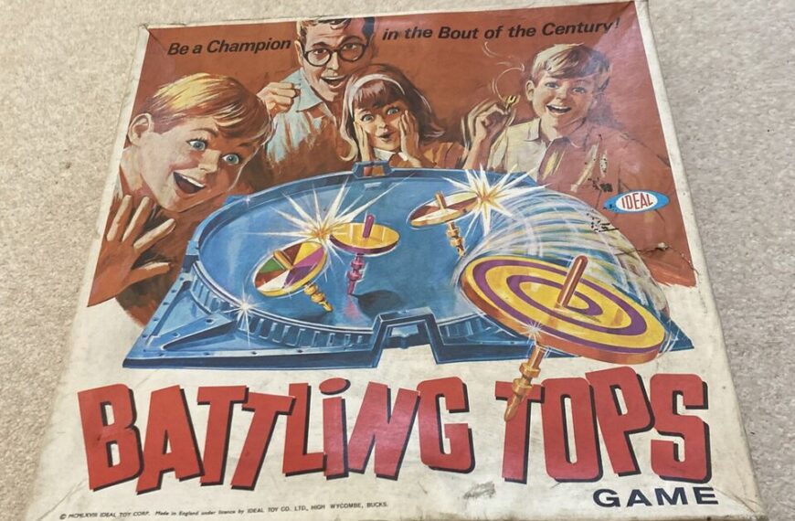 A vintage "Battling Tops" board game box with an illustrated image of excited children and a man watching tops spin in an arena, with the text "Be a Champion in the Bout of the Century!" and the Ideal Toy Company logo.