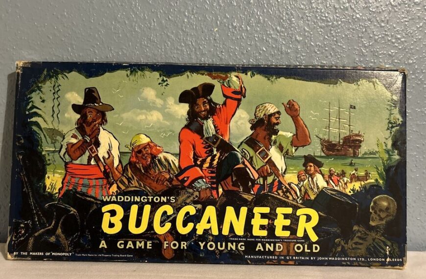 Vintage "Waddington's Buccaneer" board game box, featuring illustrated pirates and a ship in the background, with the title "A GAME FOR YOUNG AND OLD" below the artwork.