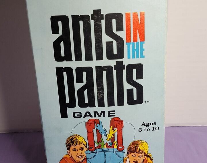 Box of the "Ants in the Pants" game featuring a cartoon image of two children playing with a pair of blue pants propelling red ants into the air, intended for ages 3 to 10.