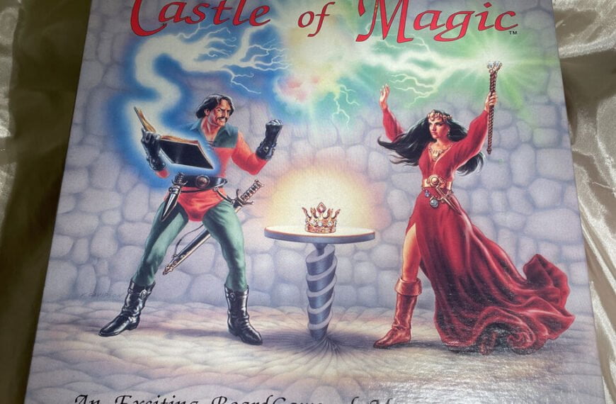 A board game titled "Castle of Magic" featuring artwork with two fantasy characters — one reading from a magical book with energy emanating from it, and the other, a female figure, holding a staff with a swirling magical aura above. A crown on a pedestal appears in the center, all set against a stone floor and a mystical blue and green cloudy background. The subtitle reads, "An Exciting Board Game of Magic & Intrigue."