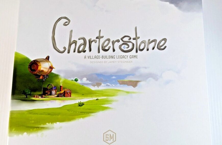 A box cover for the board game "Charterstone," which is described as a village-building legacy game designed by Jamey Stegmaier, with artwork depicting a green landscape, floating islands, and a brass-colored airship. The game is produced by Stonemaier Games.