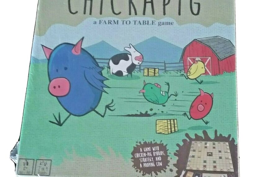 Alt text: The image shows a slightly worn board game box titled "CHICKAPIG, a FARM TO TABLE game" featuring cartoon illustrations of hybrid chicken-pig creatures, a cow, a red barn, and a pasture. Text on the box also reads "A GAME WITH CHICKEN-PIG HYBRIDS, STRATEGY, AND A POOPING COW." The corner of the box appears to be slightly damaged.