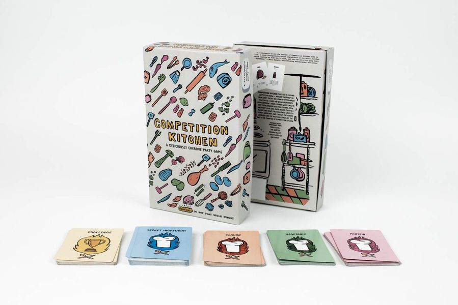 Board game "Competition Kitchen" displayed with its box and several card decks categorized as Challenge, Secret Ingredient, Flavor, Vegetable, and Protein on a white background.