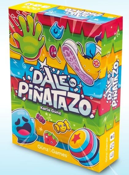 Colorful board game box titled "Dale Pinatazo" by Karla Gunz featuring vibrant cartoon graphics of a hand, shoe, and various characters.