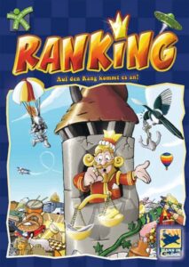 Board game cover titled "Ranking" featuring a happy king with a crown and a pair of scales inside a castle tower, surrounded by whimsical characters and objects like a flying saucer, parachuting mouse, hot-air balloons, and a treasure pile.