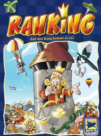 Board game cover titled "Ranking" featuring a happy king with a crown and a pair of scales inside a castle tower, surrounded by whimsical characters and objects like a flying saucer, parachuting mouse, hot-air balloons, and a treasure pile.